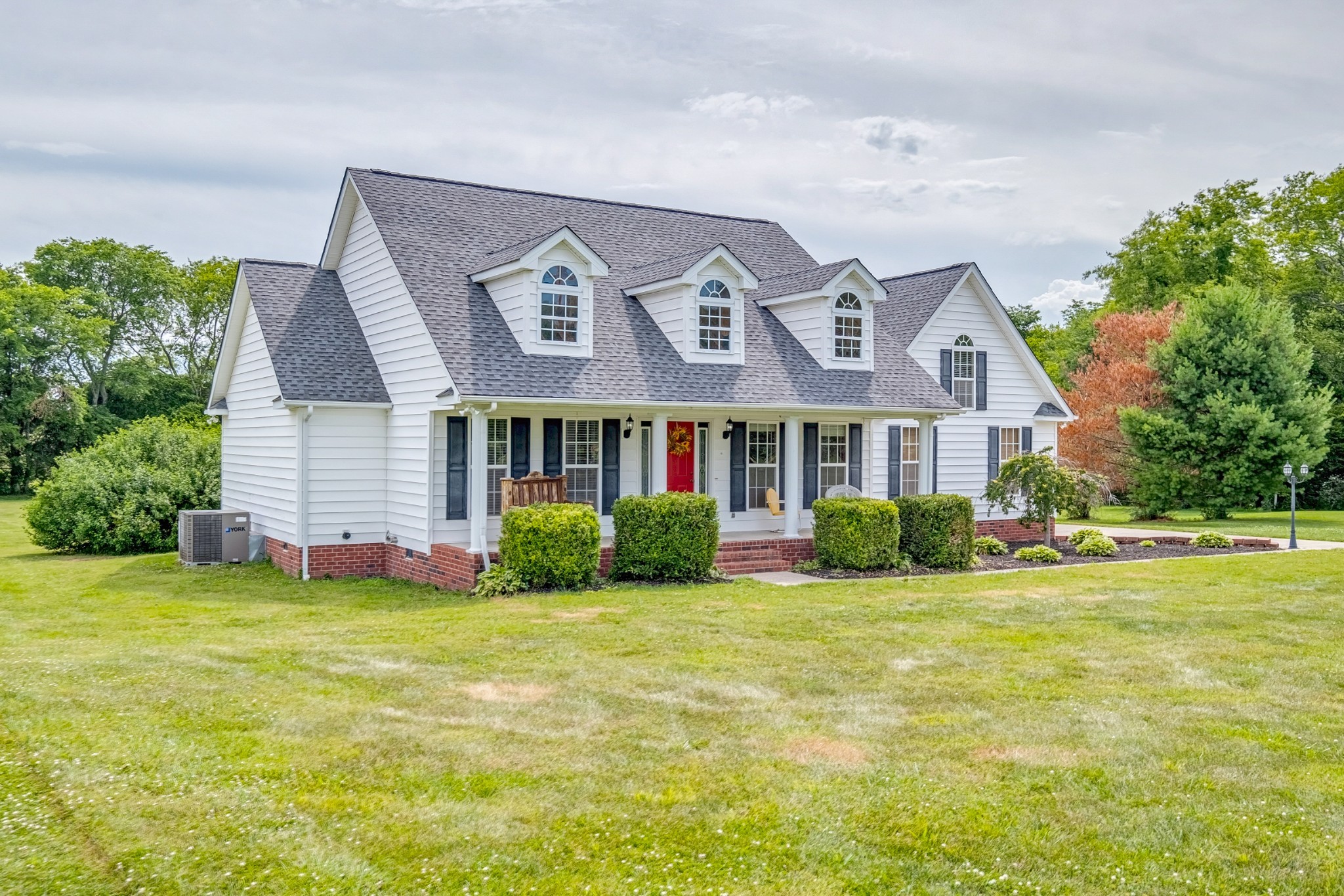 1043 Emerald Way Castalian Springs, TN 37031 - Photo 2 of 45 a front view of a house with a yard and garage