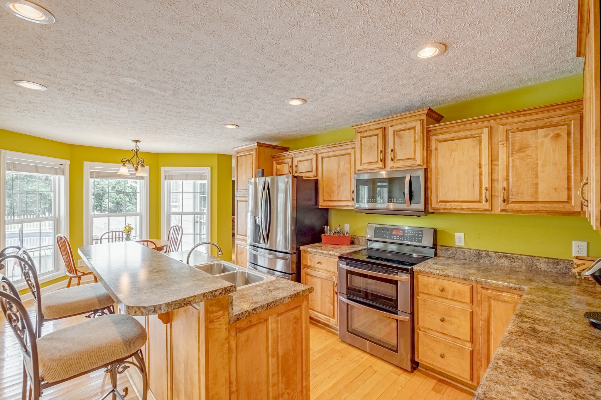 1043 Emerald Way Castalian Springs, TN 37031 - Photo 18 of 45 a kitchen with stainless steel appliances granite countertop a stove a sink and a refrigerator