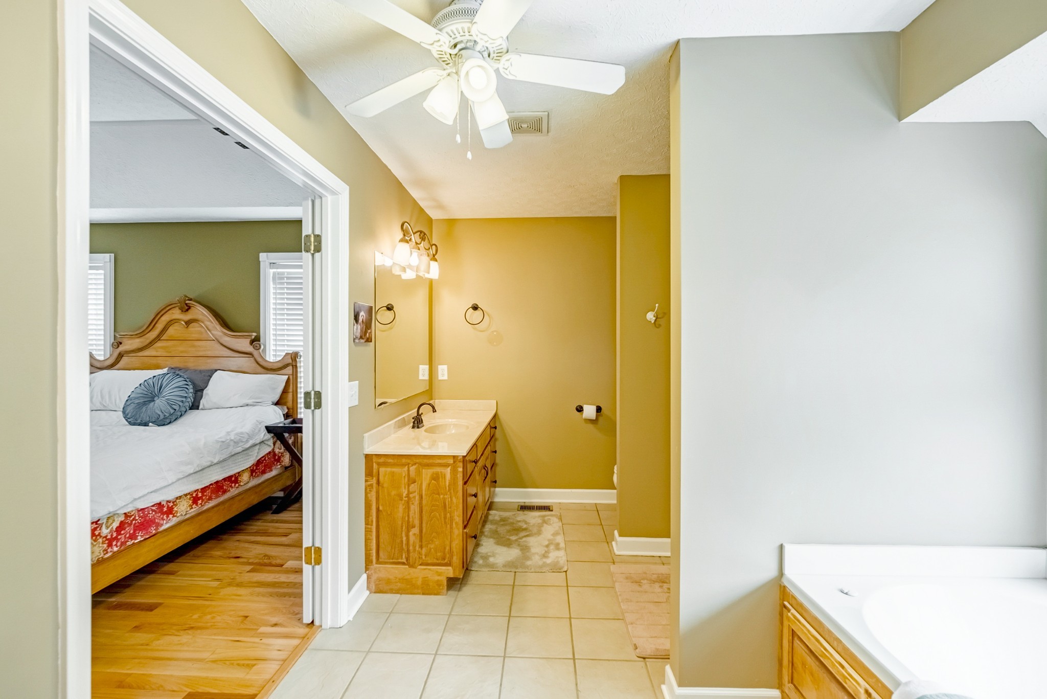 1043 Emerald Way Castalian Springs, TN 37031 - Photo 25 of 45 a bedroom with a bed and a chandelier