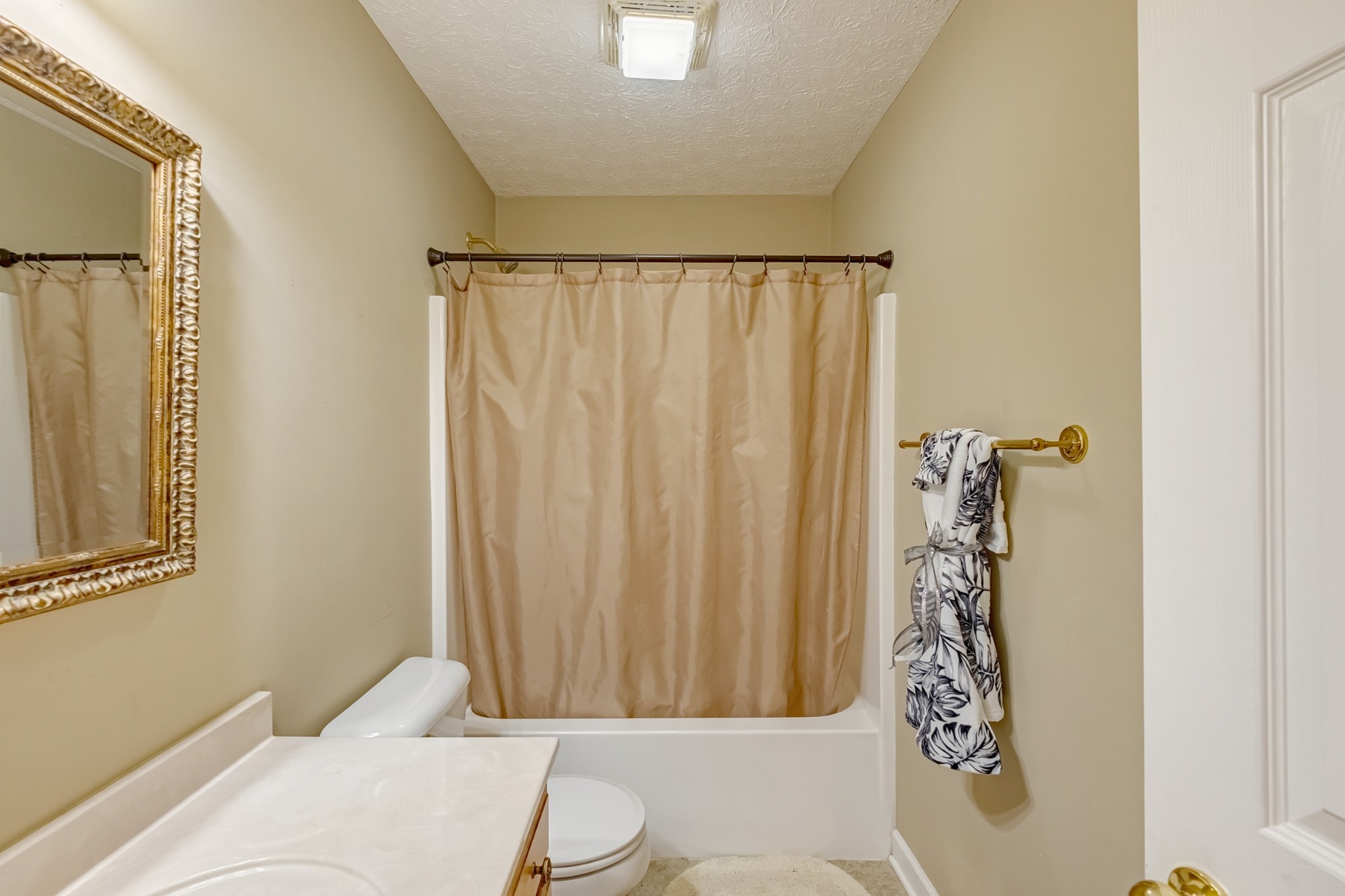 1043 Emerald Way Castalian Springs, TN 37031 - Photo 28 of 45 a bathroom with a toilet and shower curtain