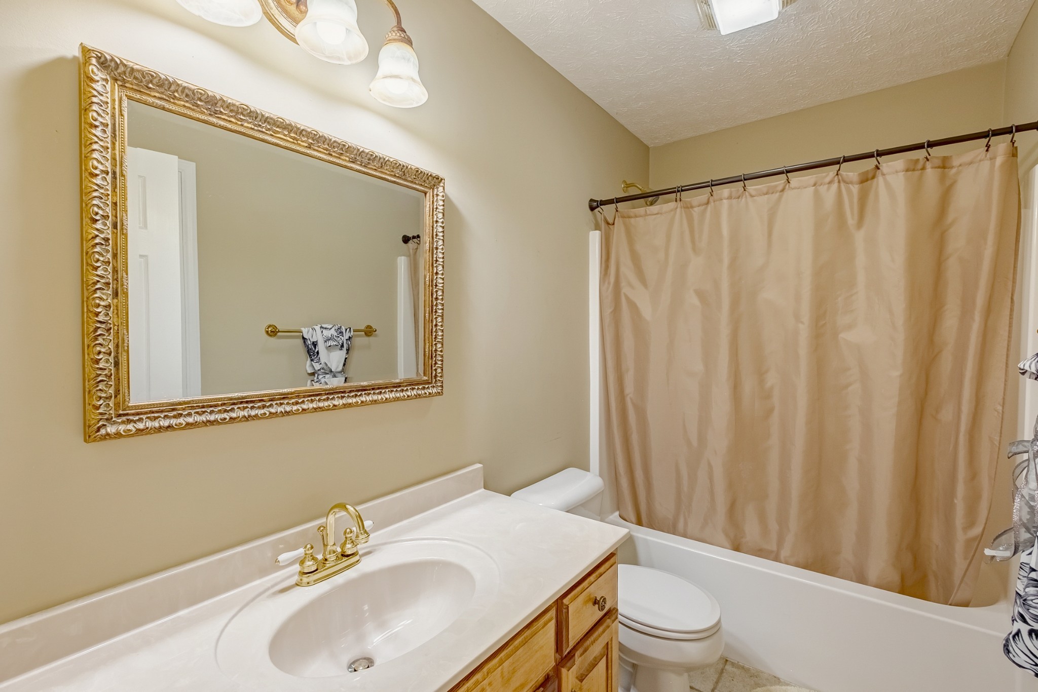 1043 Emerald Way Castalian Springs, TN 37031 - Photo 29 of 45 a bathroom with a sink toilet and mirror