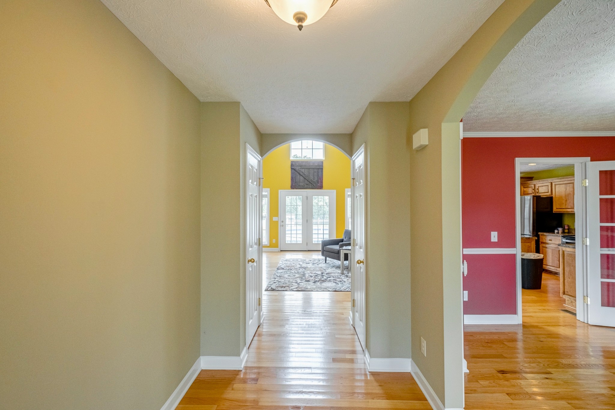 1043 Emerald Way Castalian Springs, TN 37031 - Photo 8 of 45 a view of a hallway with wooden floor windows and a kitchen