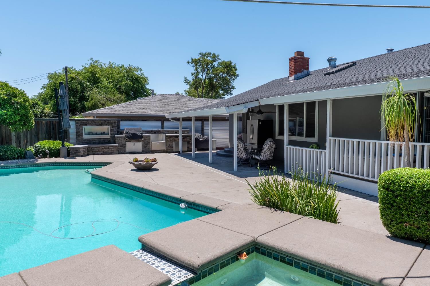 An outdoor oasis right at your backdoor! Sparkling built-in pool and spa, outdoor covered patio, outdoor kitchen with built-in bbq, 2 fireplaces, umbrella, tough shed and sitting areas. *Outdoor fridge also stays.