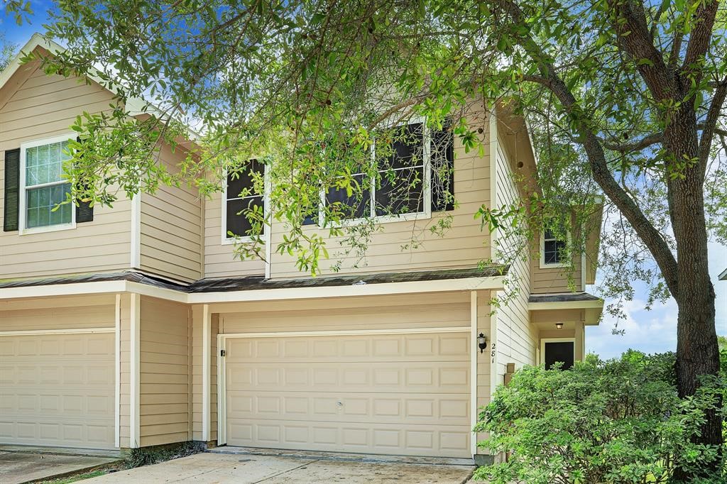 a yellow house with trees in front of it