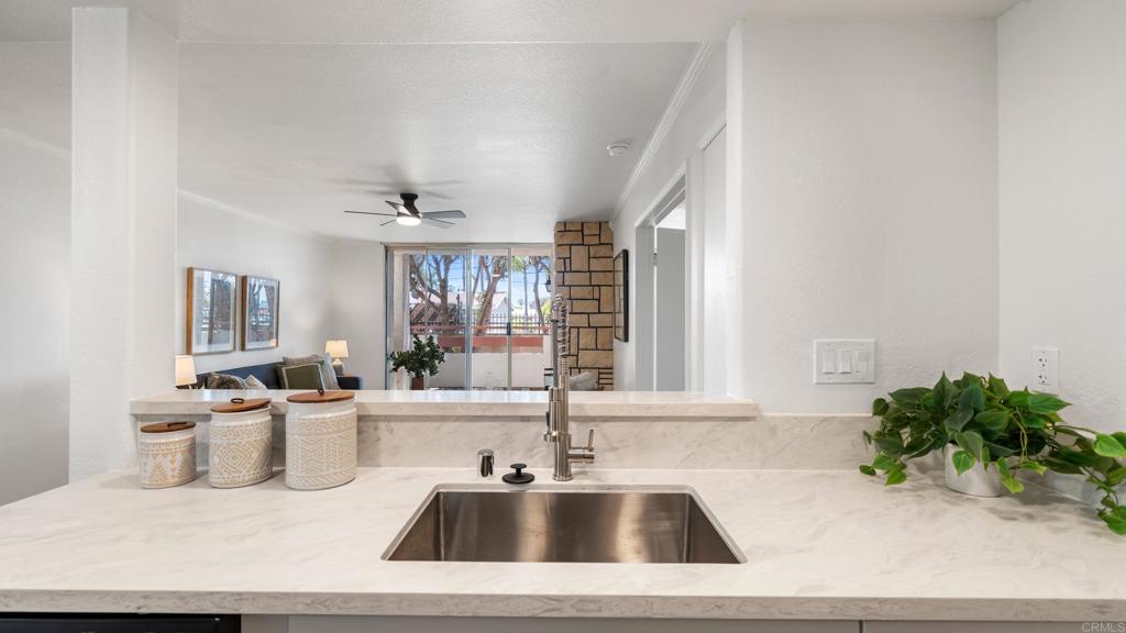 415 Stoney Point Way, Unit 106 Oceanside, CA 92058 - Photo 12 of 35 a kitchen with a sink tub and potted plant