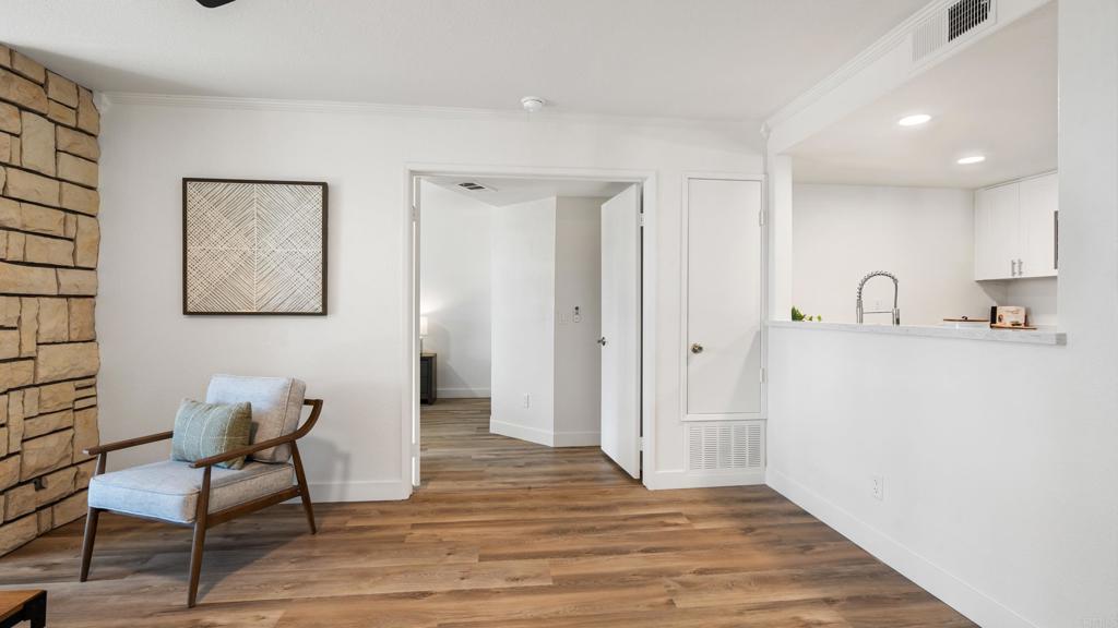 415 Stoney Point Way, Unit 106 Oceanside, CA 92058 - Photo 15 of 35 a hallway with chairs and wooden floor