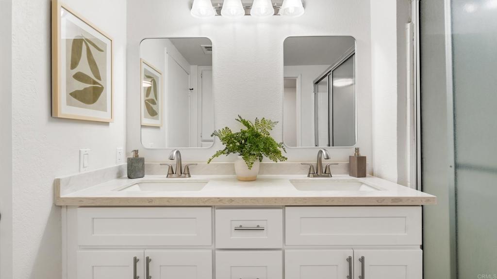 415 Stoney Point Way, Unit 106 Oceanside, CA 92058 - Photo 19 of 35 a bathroom with a sink and a mirror