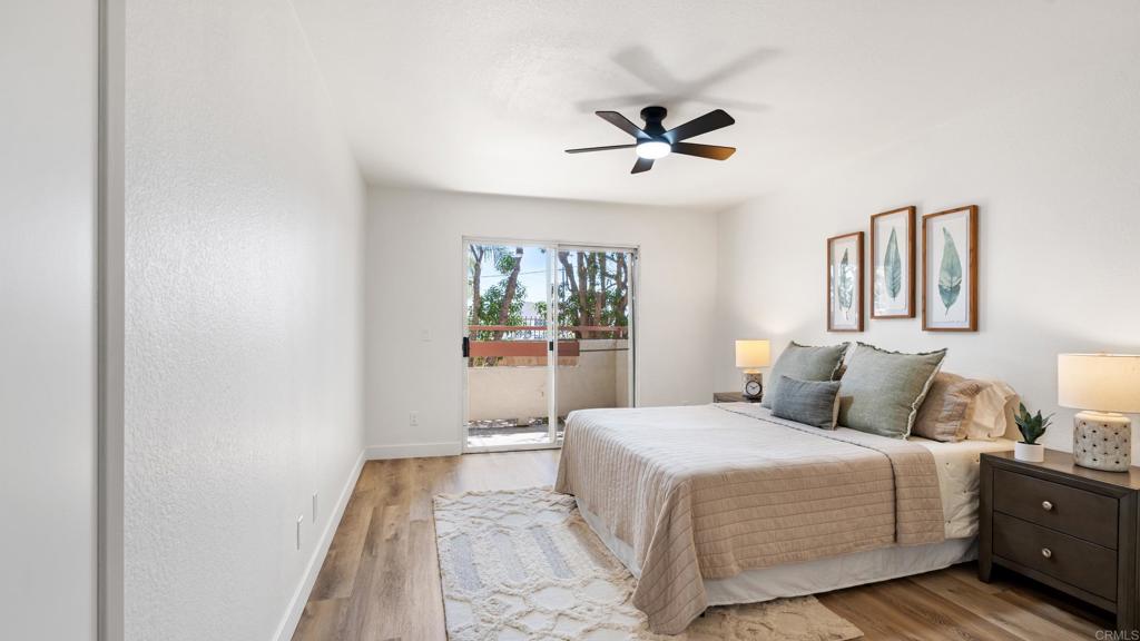 415 Stoney Point Way, Unit 106 Oceanside, CA 92058 - Photo 21 of 35 a bedroom with a large bed and a chandelier