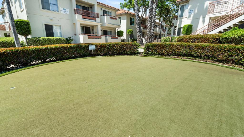 415 Stoney Point Way, Unit 106 Oceanside, CA 92058 - Photo 30 of 35 a view of a building with a garden
