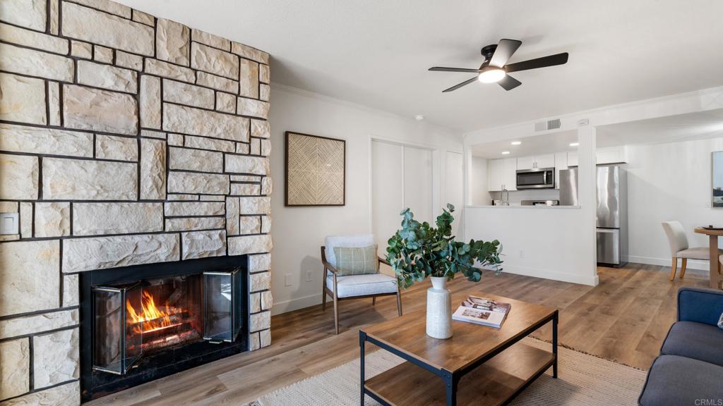 415 Stoney Point Way, Unit 106 Oceanside, CA 92058 - Photo 4 of 35 a living room with furniture and a fireplace