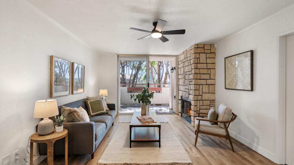 415 Stoney Point Way, Unit 106 Oceanside, CA 92058 - Photo 8 of 35 a living room with furniture and a large window