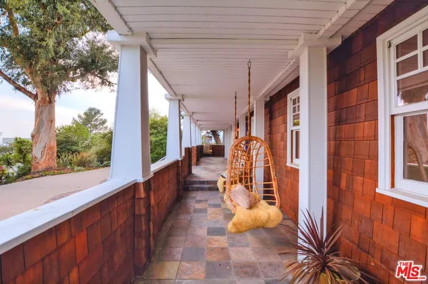 a view of a porch with wooden floor and fence
