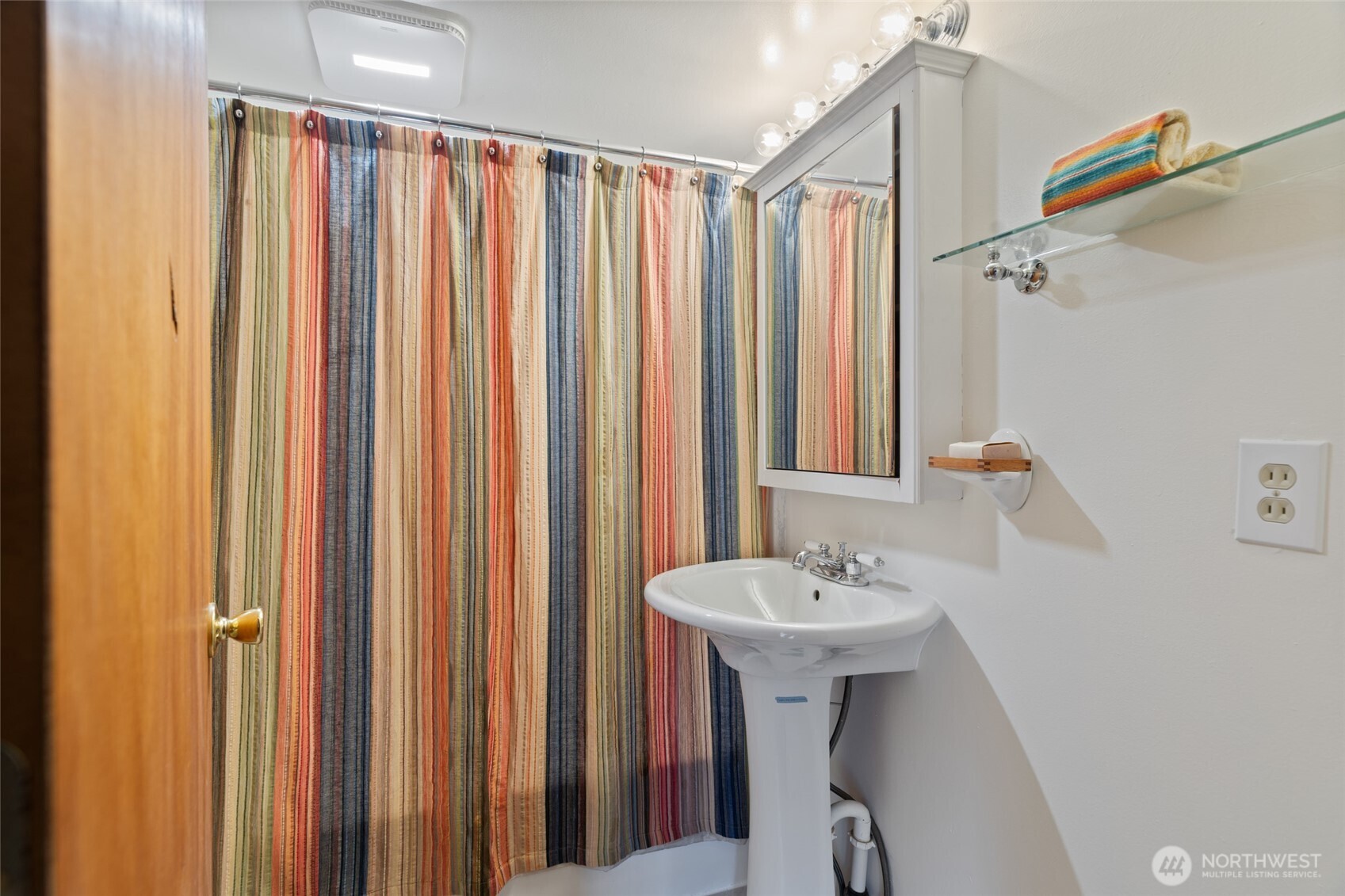 7007 Dahlberg Road Ferndale, WA 98248 - Photo 18 of 35 a bathroom with a sink a mirror and a shower curtain