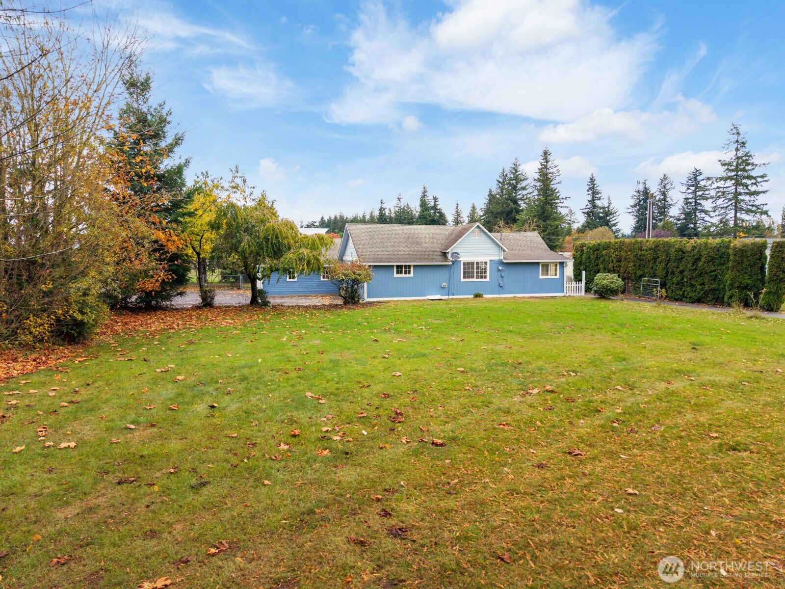 7007 Dahlberg Road Ferndale, WA 98248 - Photo 3 of 35 a view of a house with a big yard and large trees