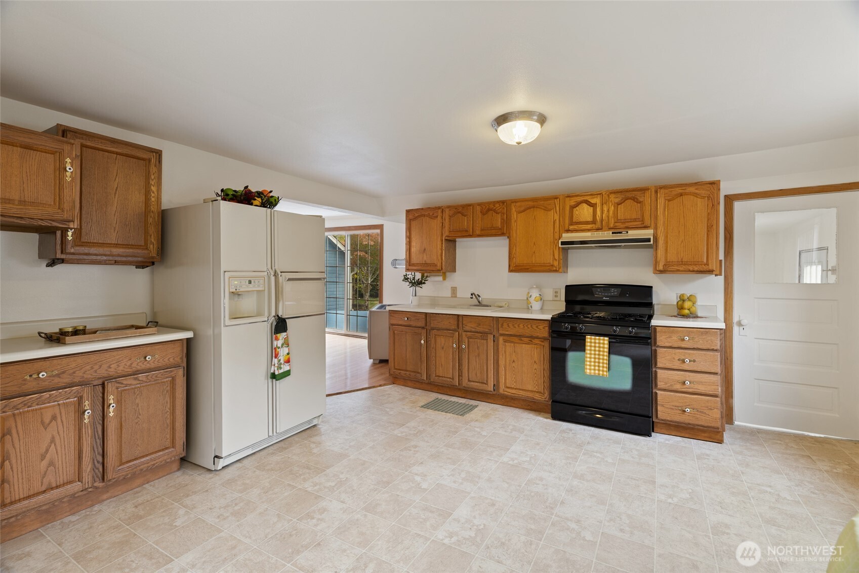 7007 Dahlberg Road Ferndale, WA 98248 - Photo 8 of 35 a kitchen with stainless steel appliances white cabinets and a refrigerator