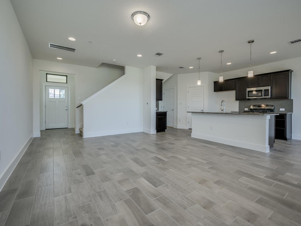 12327 Maypole Bend Austin, TX 78717 - Photo 6 of 30 a view of kitchen with kitchen island a sink stainless steel appliances and cabinets