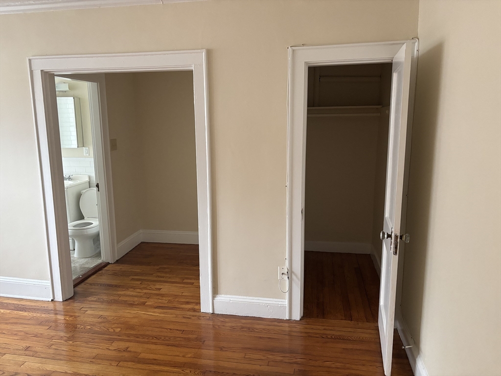 50 Broadway, Unit 34 Beverly, MA 01915 - Photo 3 of 5 an empty room and wooden floor
