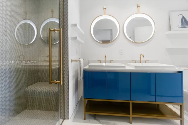 a bathroom with 2 sink and a mirror