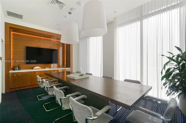 a view of a patio with chairs and potted plants