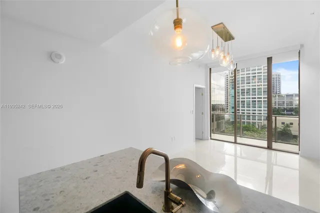 a view of a kitchen with a sink and a refrigerator