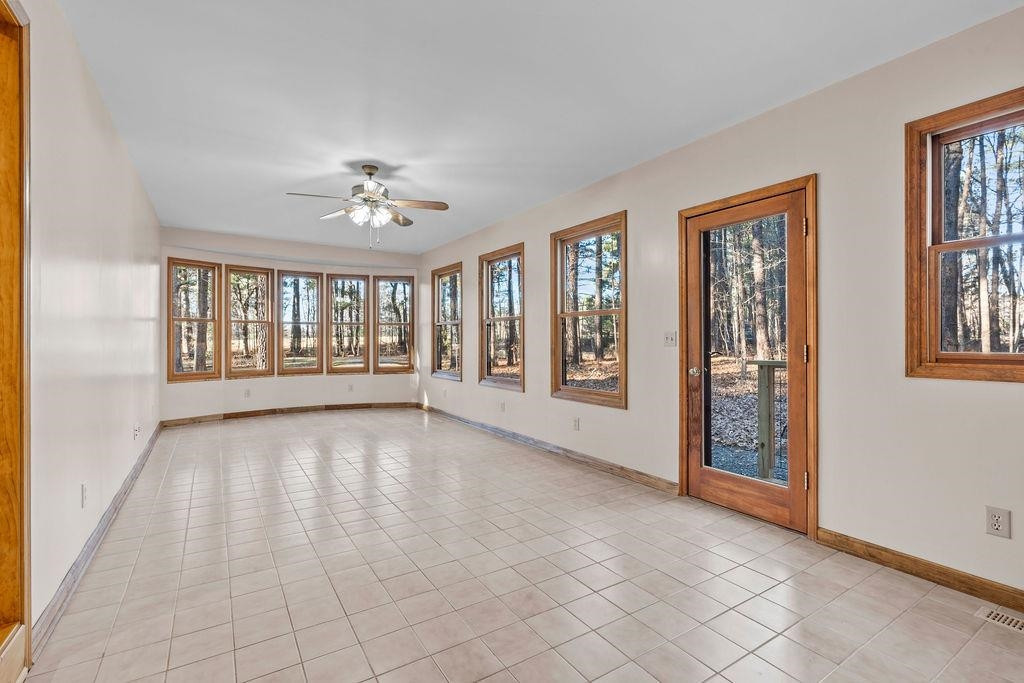8933 Barker Road New Hill, NC 27562 - Photo 10 of 30 Sun Room with Wall to Wall Windows Bringing in Loads of Natural Light
