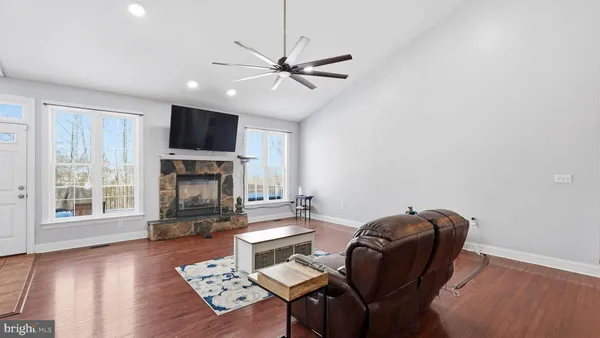 a living room with furniture and kitchen view