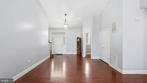 a kitchen with stainless steel appliances a sink cabinets and wooden floor