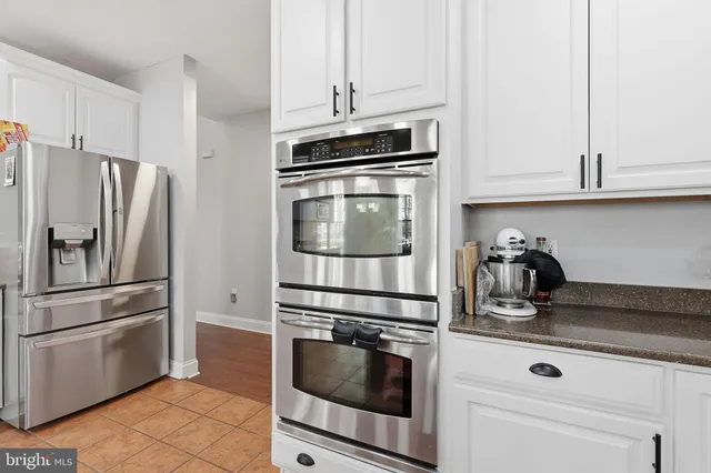 a kitchen with stainless steel appliances granite countertop a sink and cabinets