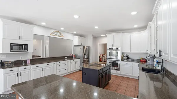 a kitchen with a sink a stove and cabinets