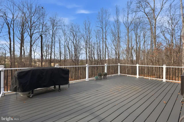 a living room with furniture hardwood floor and a large window
