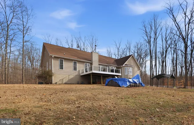 a front view of house with sign board and yard