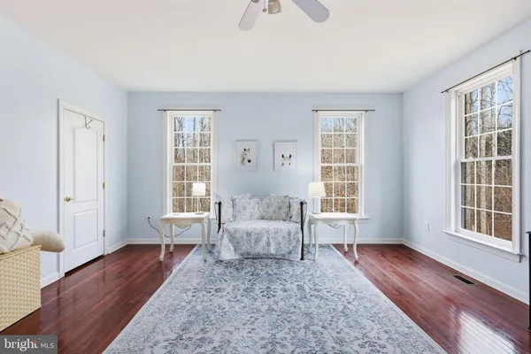 a living room with furniture wooden floor and a window