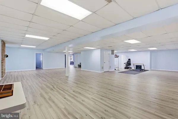 a kitchen with stainless steel appliances kitchen island granite countertop a refrigerator cabinets and wooden floor