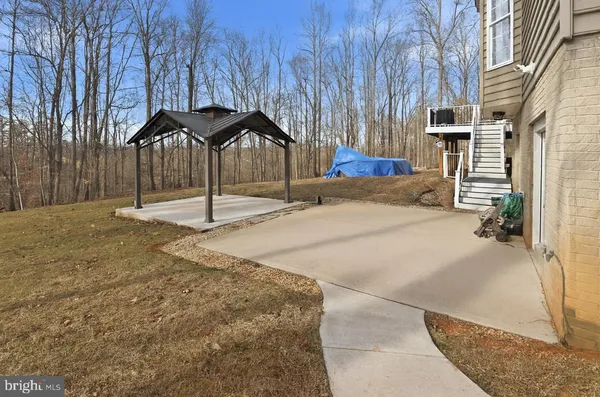 a backyard of a house with table and chairs