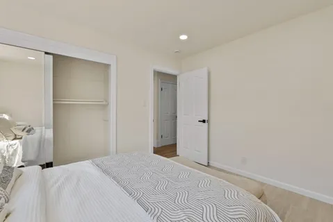 a bedroom with a bed and a bathroom