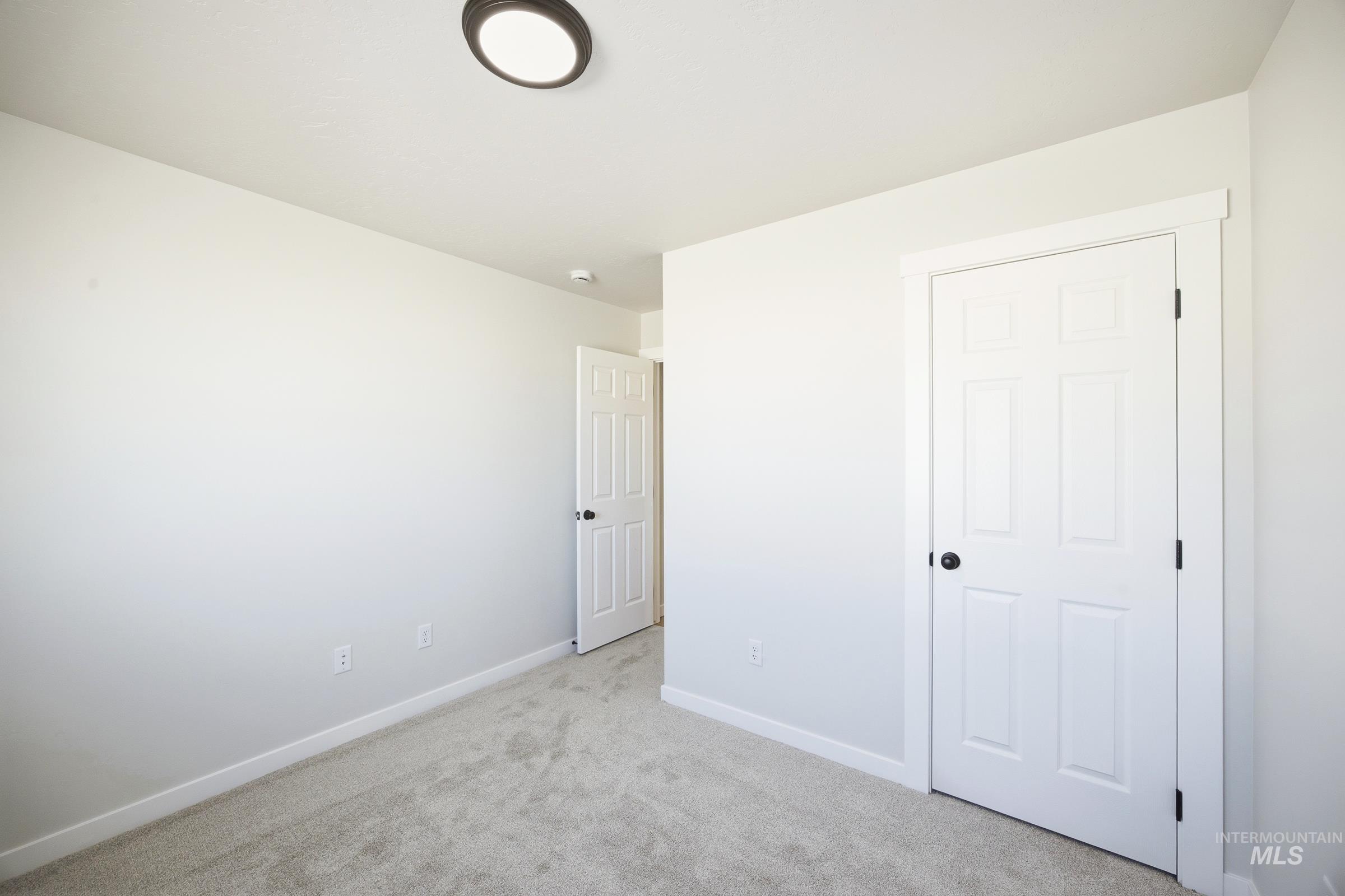 12841 Decatur Street Nampa, ID 83651 - Photo 14 of 30 Light gray wall color with white trim and carpeting