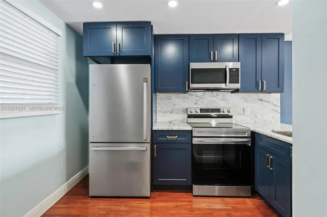 a kitchen with a refrigerator and a sink