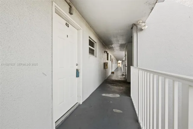 a view of a hallway with white walls