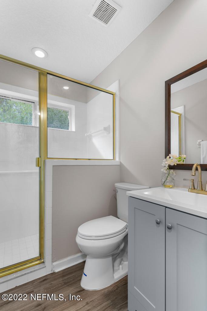 1229 Paradise Pond Road St. Augustine, FL 32092 - Photo 13 of 23 a bathroom with a toilet a sink and a mirror