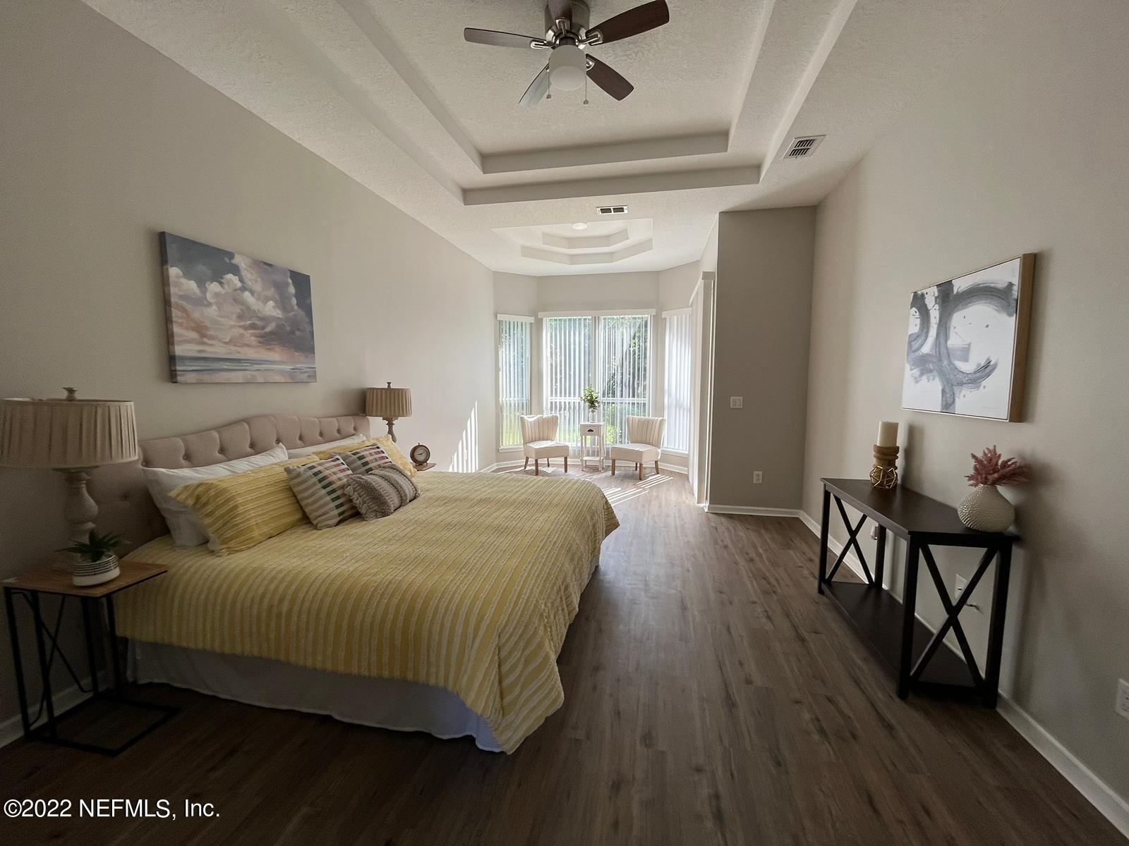 1229 Paradise Pond Road St. Augustine, FL 32092 - Photo 16 of 23 a bedroom with a bed and wooden floor