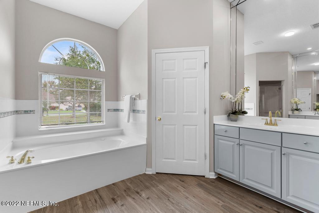 1229 Paradise Pond Road St. Augustine, FL 32092 - Photo 21 of 23 a spacious bathroom with a window a sink and a mirror