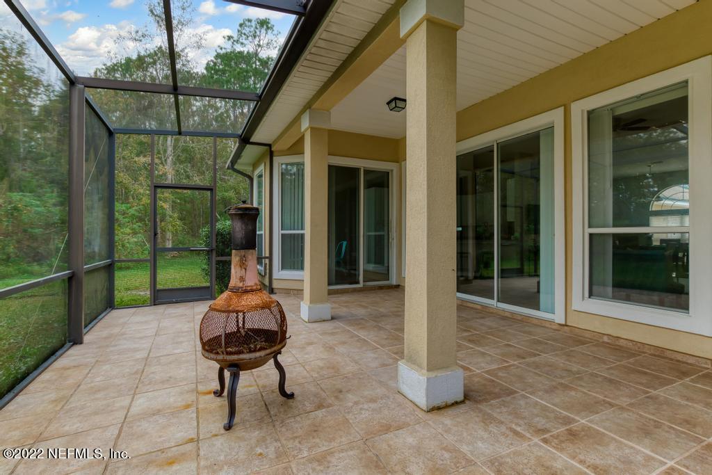1229 Paradise Pond Road St. Augustine, FL 32092 - Photo 22 of 23 a view of a porch with a table and chairs