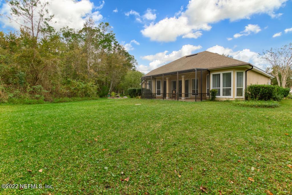 1229 Paradise Pond Road St. Augustine, FL 32092 - Photo 23 of 23 a view of a house with a big yard and large trees