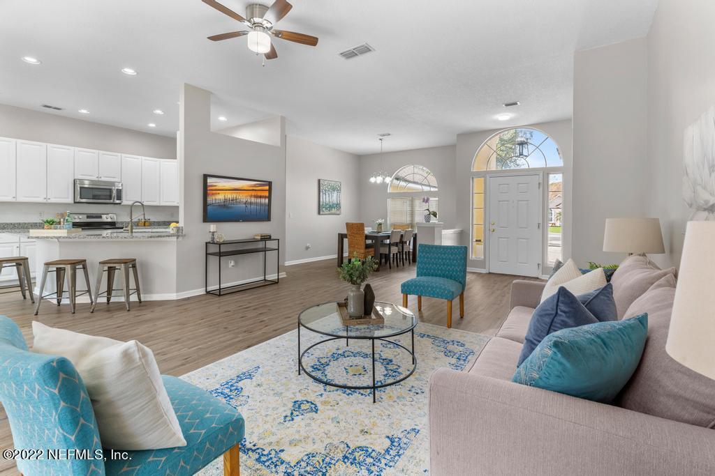 1229 Paradise Pond Road St. Augustine, FL 32092 - Photo 5 of 23 a living room with fireplace furniture and a flat screen tv