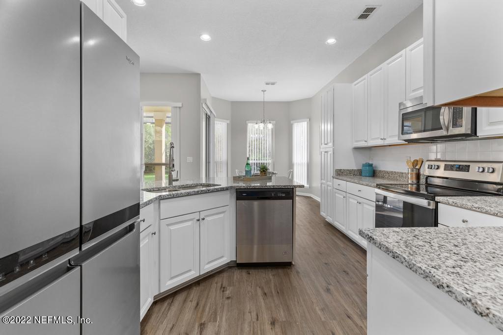 1229 Paradise Pond Road St. Augustine, FL 32092 - Photo 8 of 23 a large kitchen with stainless steel appliances granite countertop a lot of counter space and a sink