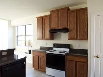 a kitchen with stainless steel appliances a sink a stove a microwave a refrigerator and cabinets