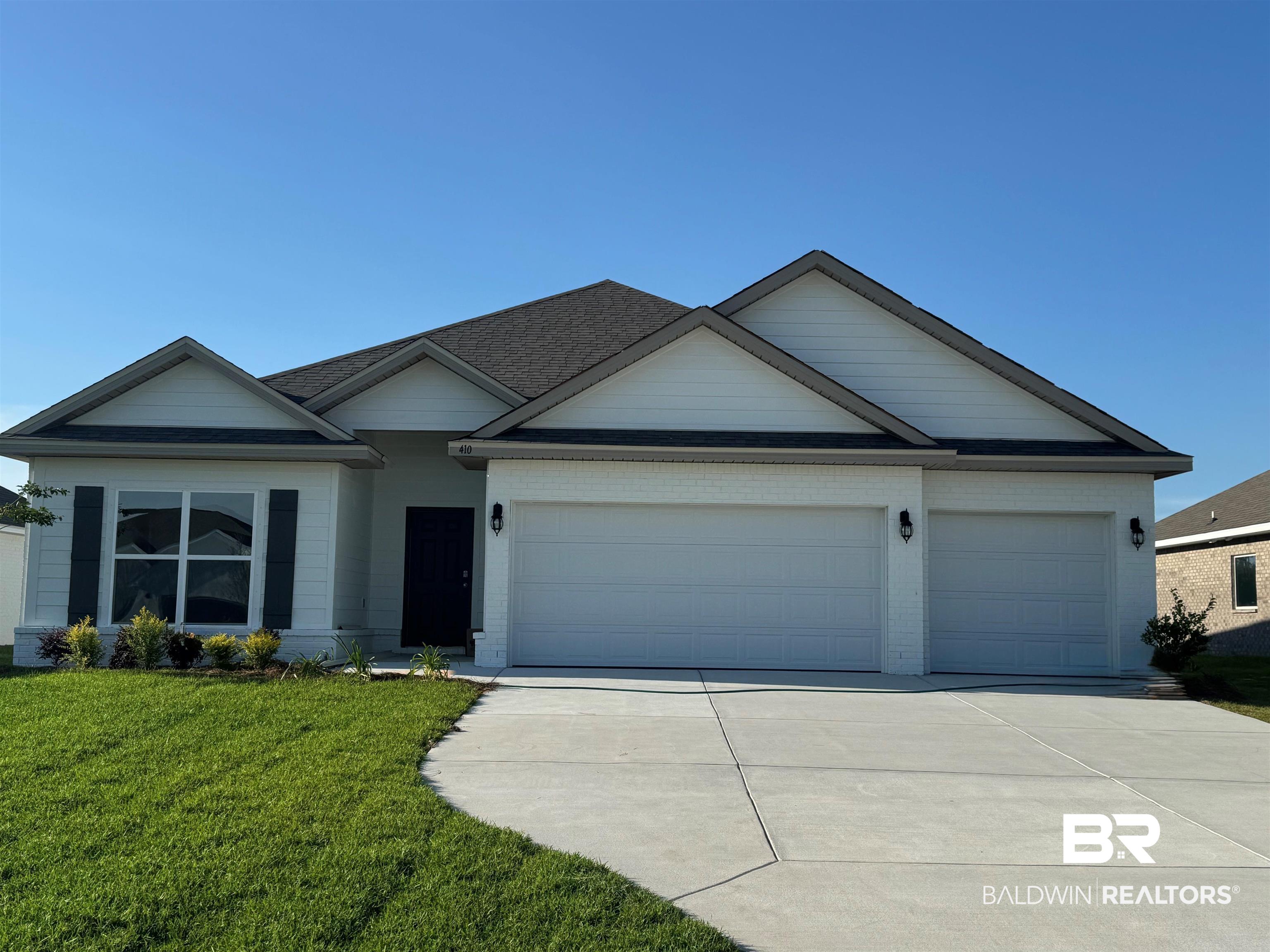 410 Raley Farms Drive Gulf Shores, AL 36542 - Photo 1 of 46 Single story home with concrete driveway, an attached garage, a front yard, and brick siding