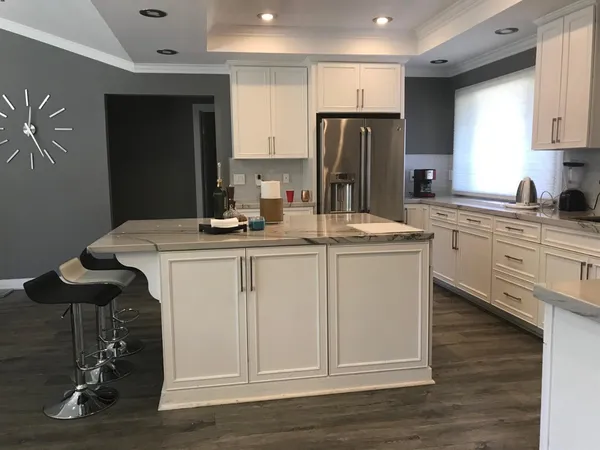a kitchen with a sink stainless steel appliances and cabinets