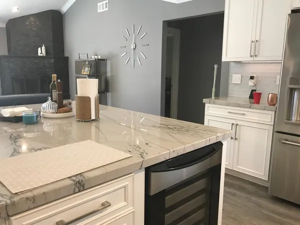 a kitchen with stainless steel appliances a stove a sink a microwave a refrigerator and cabinets