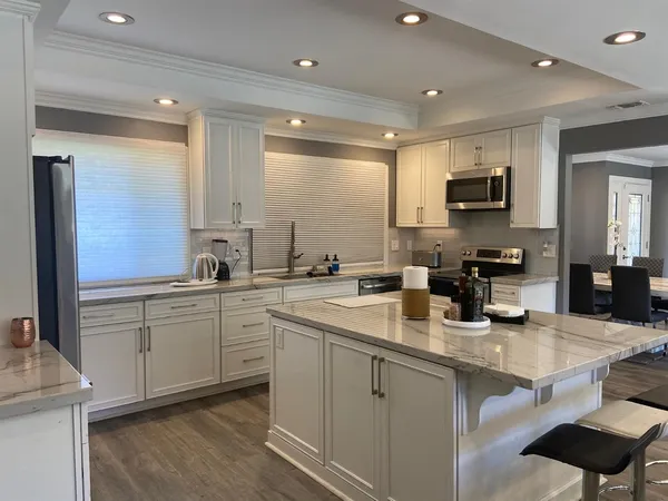a kitchen with a sink cabinets and wooden floor